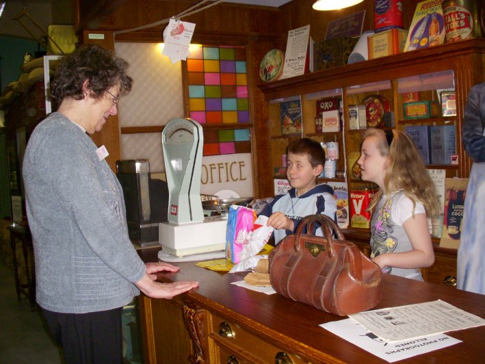 Children serving behind the counter in the Saturday Club